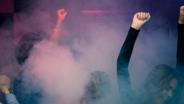 Woman Wearing Black Long-sleeved Shirt Dancing With Smoke